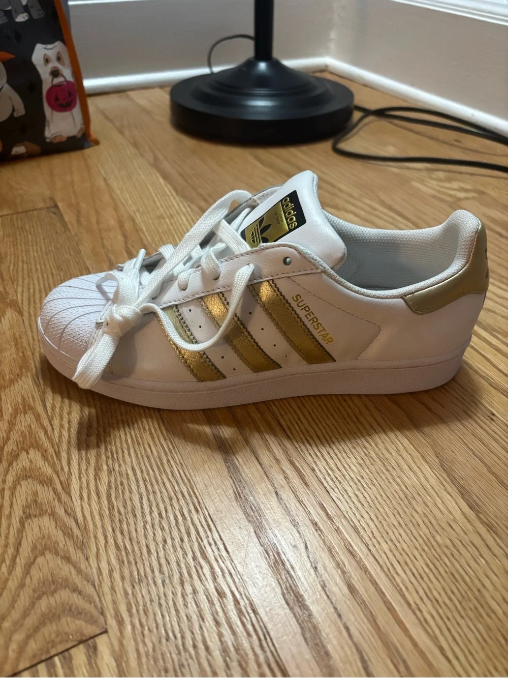 adidas Women's White Sneakers with Gold Stripe Accents